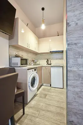 a kitchen with a washing machine and a washer at Studio in Sarafovo with Private Parking Spot by Flat Mаnаger in Burgas City