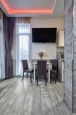 a kitchen and dining room with a table and chairs at Studio in Sarafovo with Private Parking Spot by Flat Mаnаger in Burgas City