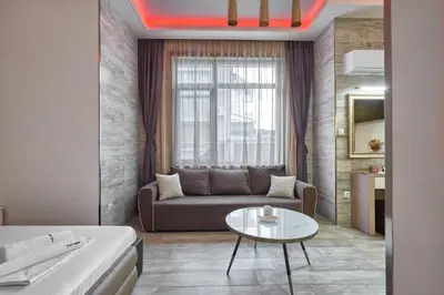 a living room with a couch and a table at Studio in Sarafovo with Private Parking Spot by Flat Mаnаger in Burgas City