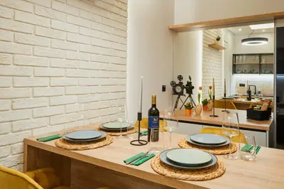 a table with plates and wine glasses on it at Florance Rentals Luxury Apartments in Burgas in Burgas City