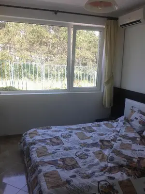 a bedroom with a bed in front of a window at Caprice Apartment in Lozenec in Kiten