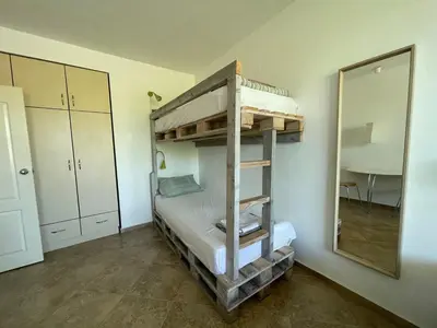 a bunk bed in a room with a mirror at Caprice Apartment in Lozenec in Kiten