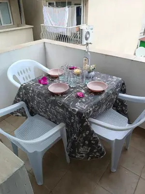 a table with plates and glasses on top of it at Стаи за гости Ники in Nesebar