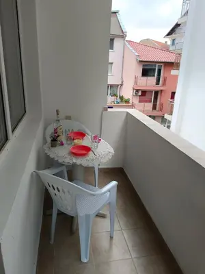 a small table and a chair on a balcony at Стаи за гости Ники in Nesebar