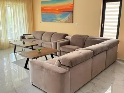 a living room with a couch and a table at Luxury Sea Villas - Kabalan in Burgas City