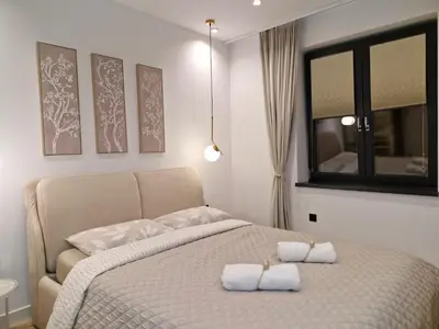 a bedroom with a bed with two towels on it at Apartment Marbél - Designer Retreat with FREE parking in Burgas City