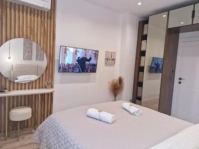a bedroom with a bed with two towels on it at Apartment Marbél - Designer Retreat with FREE parking in Burgas City