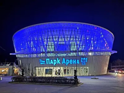 a building with a sign in front of it at night at Central Park Galleria in Burgas City