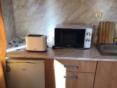 a kitchen counter with a microwave and a toaster at Panorama Dreams - Sveti Vlas - Furnished Apartment with a Terrace and a Sea View in Sveti Vlas