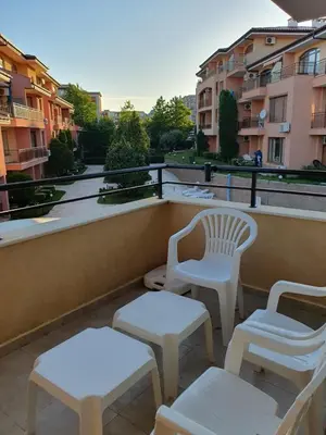 a balcony with two chairs and two tables and chairs at Panorama Dreams - Sveti Vlas - Furnished Apartment with a Terrace and a Sea View in Sveti Vlas