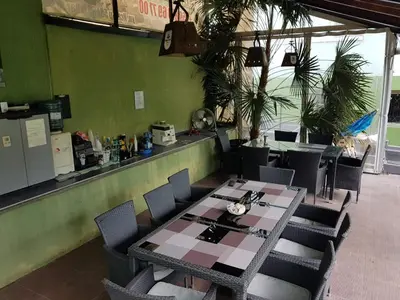 a dining room with a table and chairs in a restaurant at Aheloy Apartments in Aheloy
