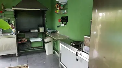 a kitchen with green walls and a white counter top at Aheloy Apartments in Aheloy