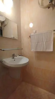 a bathroom with a sink and a mirror and towels at Студия Sunset Beach Солнечный Берег in Sunny Beach