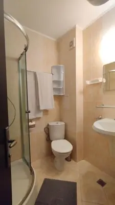 a bathroom with a toilet and a sink and a shower at Студия Sunset Beach Солнечный Берег in Sunny Beach