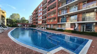 a swimming pool in front of a building at Студия Sunset Beach Солнечный Берег in Sunny Beach