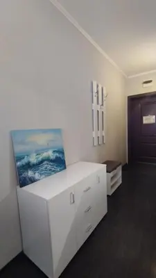 a room with a white desk and a painting on the wall at Студия Sunset Beach Солнечный Берег in Sunny Beach