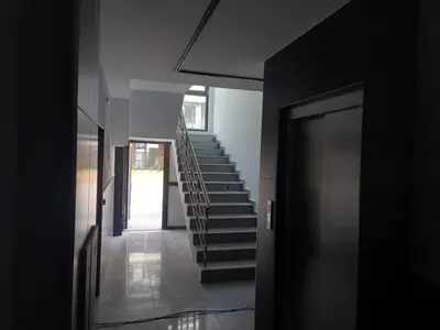 a hallway of a house with stairs and a door at Сарафово Лукс Гарден Първа Линия in Burgas City