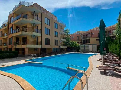 a large swimming pool in front of a building at Three-room apartment in Sveti Vlas