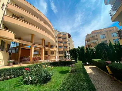 a large building with a garden in front of it at Three-room apartment in Sveti Vlas