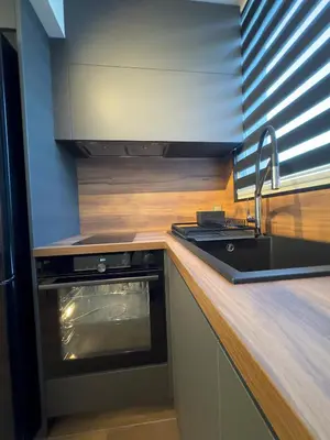 a kitchen with a sink and a stove top oven at SeaView Lazur Apartment in Burgas City