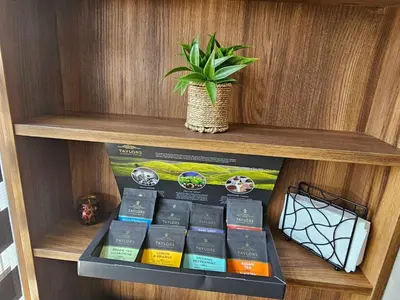 a shelf with books and a potted plant on it at SeaView Lazur Apartment in Burgas City