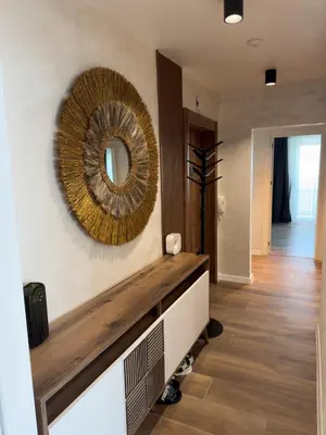 a living room with a mirror on the wall at SeaView Lazur Apartment in Burgas City