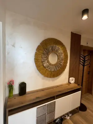 a mirror on the wall of a living room at SeaView Lazur Apartment in Burgas City