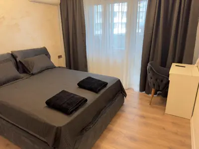 a bedroom with a bed with two pillows on it at SeaView Lazur Apartment in Burgas City