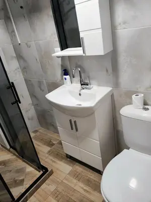 a bathroom with a toilet and a sink and a shower at Apartment SUN RAYS Nesebar in Nesebar