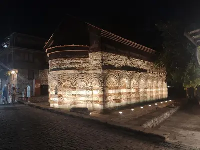 a stone building with lights on it at night at Apartment SUN RAYS Nesebar in Nesebar