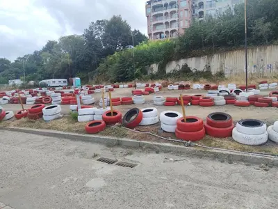 a lot of red and white barrels in a parking lot at Apartment SUN RAYS Nesebar in Nesebar