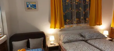 a bedroom with a bed with yellow curtains at Studio GALILEO in Burgas City