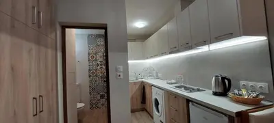 a small kitchen with a sink and a washing machine at Studio GALILEO in Burgas City