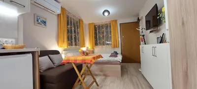 a small living room with a couch and a table at Studio GALILEO in Burgas City
