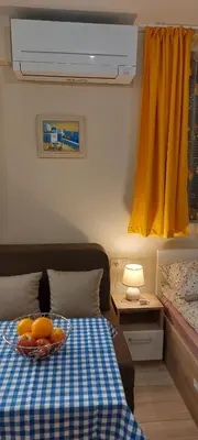 a bowl of fruit on a bed in a room at Studio GALILEO in Burgas City