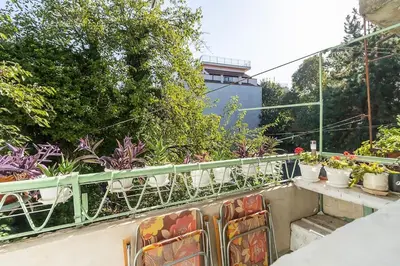 a balcony with potted plants on a building at Римски Терми Варна in Varna City