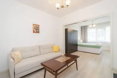 a living room with a couch and a table at Римски Терми Варна in Varna City