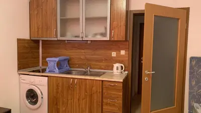 a kitchen with a sink and a washing machine at Stamopolu Parter in Primorsko