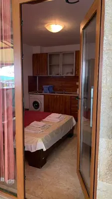 a small room with a bed in a kitchen at Stamopolu Parter in Primorsko