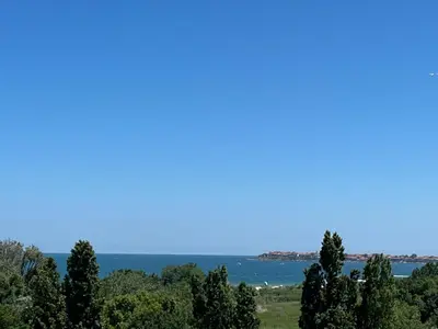 a view of the ocean with trees in the foreground at River park 2 bedroom apartment in Nesebar