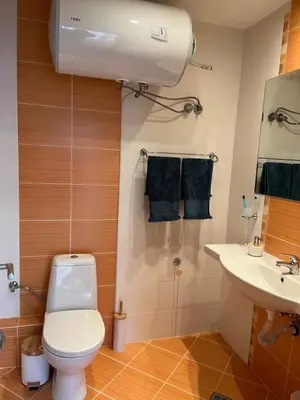 a bathroom with a toilet and a sink at River park 2 bedroom apartment in Nesebar