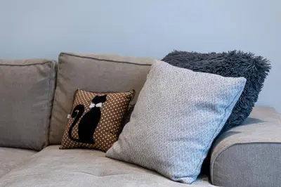 a couch with two pillows sitting on it at Modern & Stylish Sea Apartment with Parking in Burgas City