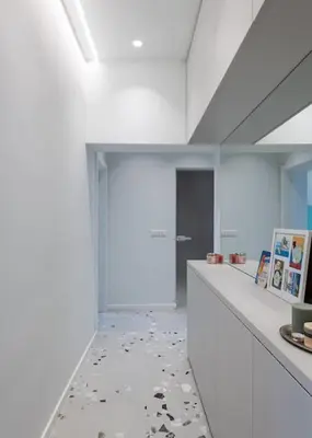 a white room with a long counter with paintings on it at Modern & Stylish Sea Apartment with Parking in Burgas City