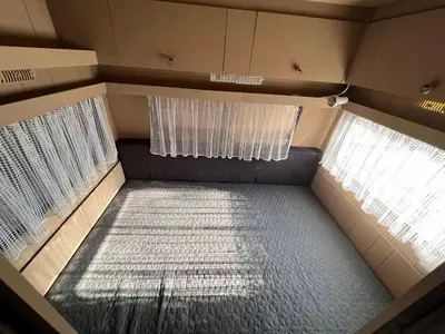 an emptyruck with two windows and a bed in it at Лятна каравана “Айтата” in Kiten
