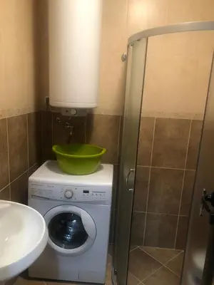 a bathroom with a green bowl on top of a washing machine at Studio Sveti Vlas SEA BREEZE 3 in Sveti Vlas