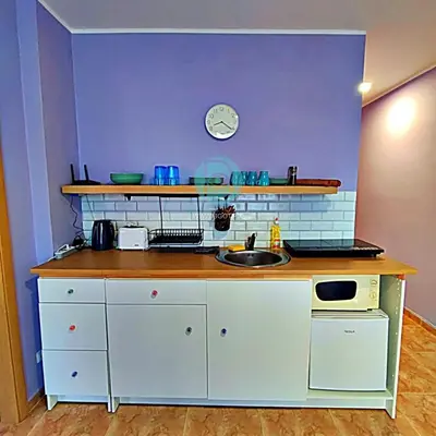 a kitchen with a sink and a clock on the wall at BRAVO 5 - Sunny Beach Center in Sunny Beach