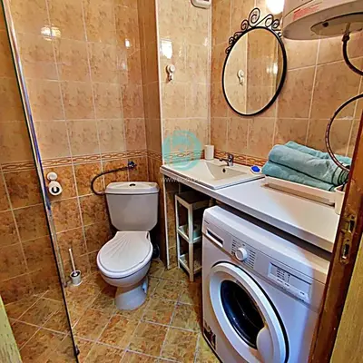 a bathroom with a toilet and a sink and a washing machine at BRAVO 5 - Sunny Beach Center in Sunny Beach