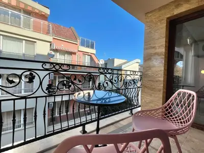 a balcony with two chairs and a table on a balcony at Valencia Gardens - Private apartment - BSR in Nesebar