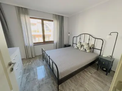 a bedroom with a bed and a window at Valencia Gardens - Private apartment - BSR in Nesebar