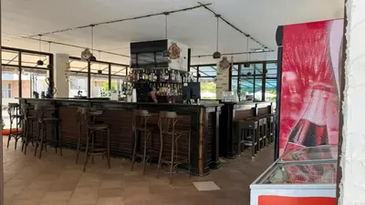 a bar with bar stools in a restaurant at Top Studio in Big Kamelia Holiday Complex Sunny Beach in Sunny Beach
